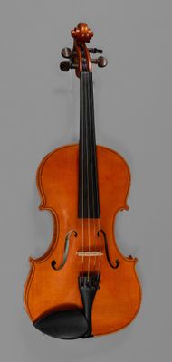 an old violin sitting on top of a table next to a wall