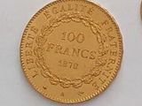 an image of a gold coin and a silver coin on a white surface