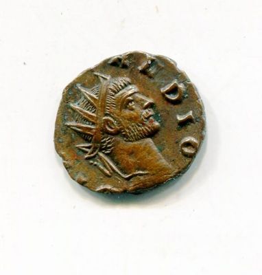 an old coin with a man on it on a white surface