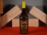 a bottle of wine sitting on a table next to a stack of wooden blocks