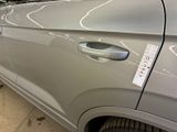 a silver car with a sticker on the side of it