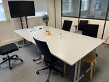 a white table with chairs and a fan in a room