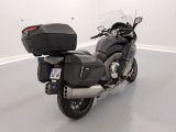 a black motorcycle parked in a white room