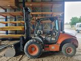 a forklift that is parked in front of a building