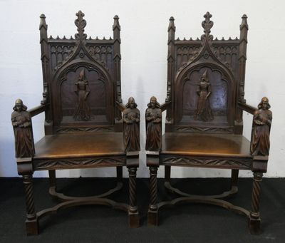 paire de chaises anciennes de style gothique en bois sculpté, avec des housses d'assise en tissu