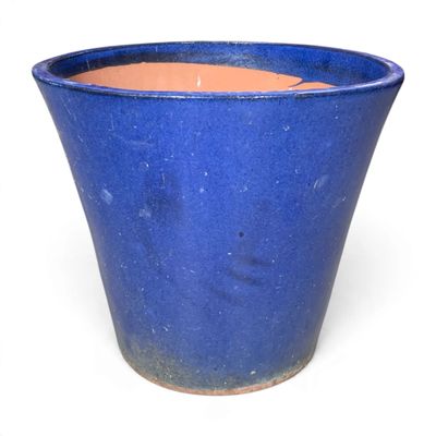 a blue pot that is sitting on a white surface