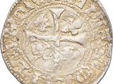 an old silver coin with a cross on it