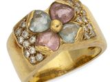 a close up of a gold ring with a flower design