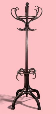 a coat stand with a coat rack on it on a pink background