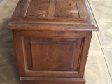 an old wooden chest sitting on top of a hard wood floor
