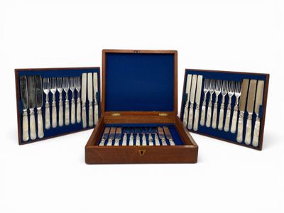 an image of a set of silverware in a wooden case
