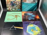 several pink floyd albums are on display in a glass case