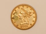 a close up of a gold coin on a white surface