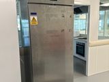 a large stainless steel refrigerator in the middle of a room