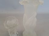 two glass vases sitting next to each other on a table