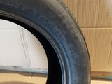 a close up of a tire on a wooden floor next to a cardboard box