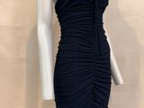 the mannequin is wearing a black dress with a ruched skirt