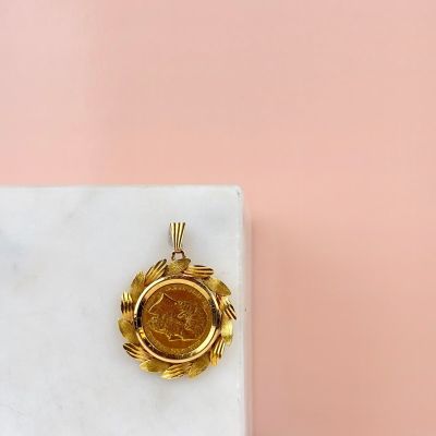 une image représentant une pièce d'or posée sur un bloc de marbre