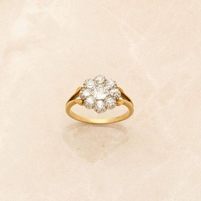 a close up of a diamond ring on a marble surface