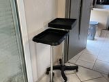 a black stool sitting in the corner of a kitchen