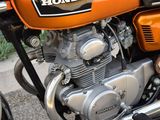 an orange motorcycle parked on the side of the street