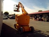 an image of a man on a cherry picker in a parking lot