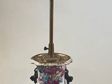 a lamp that is sitting on a table with a bird on it