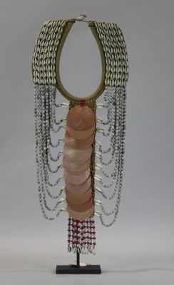beaded necklace on stand with chain and bead fringes