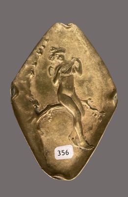 gros plan d'une pièce d'or sur laquelle figure un homme