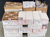 Plusieurs cartons de courrier sont empilés sur une palette devant un mur noir.