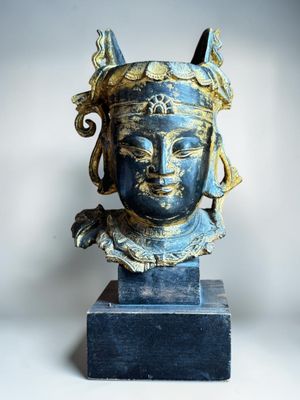 an image of a statue of a woman ' s head on a marble base