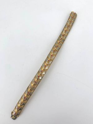 a close up of a gold colored metal object on a white surface