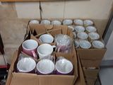 many cups in a box on the floor next to each other