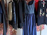 a lot of clothes hanging on a rack in a room