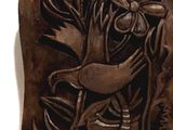 a close up of a plaque with a bird and flowers on it