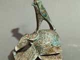 statue of a man on a turtle with a hat on his head