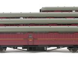 several red and green train cars are lined up on a white surface