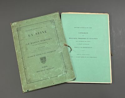 an old book sitting on top of a table next to a green book