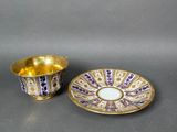 a close up of a cup and saucer on a table