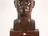 an image of a bronze bust of a man on a wooden base