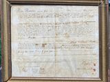 an old document with writing on it in a wooden frame