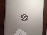 a laptop with a sticker on it sitting on a desk