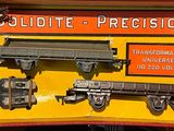 a yellow box with a train on it and a sign on the side of it