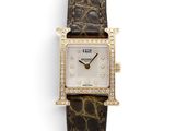 a close up of a wrist watch with diamonds on the face