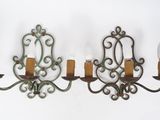two wall sconces that are hanging on the wall