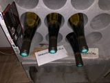 three wine bottles that are sitting on a shelf