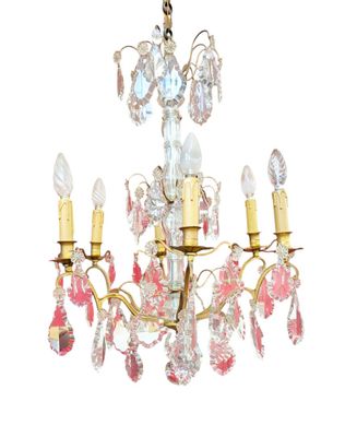 a close up of a chandelier with pink and white flowers