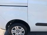 a white van parked in a parking lot with its door open