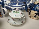 many different types of teapots and saucers on the table