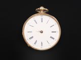 an antique gold pocket watch with roman numerals on the face